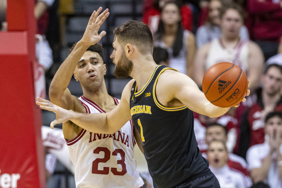 Indiana forward Trayce Jackson-Davis (23) defends Michigan center Hunter Dickinson (1) during the second half of an NCAA college basketball game, Sunday, March 5, 2023, in Bloomington, Ind. (AP Photo/Doug McSchooler)