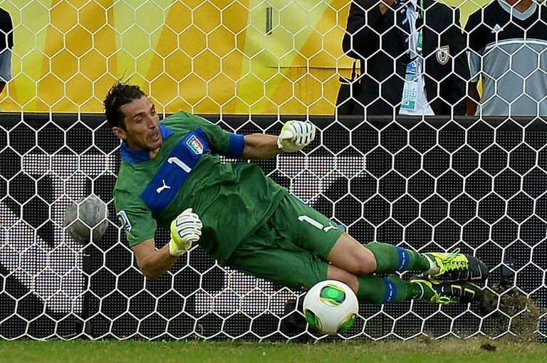 Italy's goalkeeper Gianluigi Buffon stops the penalty taken by Uruguay's forward Diego Forlan during the penalty shoot-out of their FIFA Confederations Cup Brazil 2013 third-place football match, at the Fonte Nova Arena in Salvador, on June 30, 2013. Italy beat Uruguay 3-2 on penalties