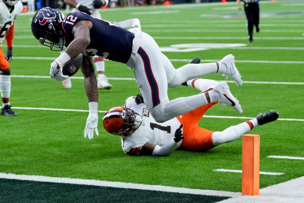 Houston Texans wide receiver Nico Collins scores over Cleveland Browns safety Juan Thornhill on Saturday in Houston.