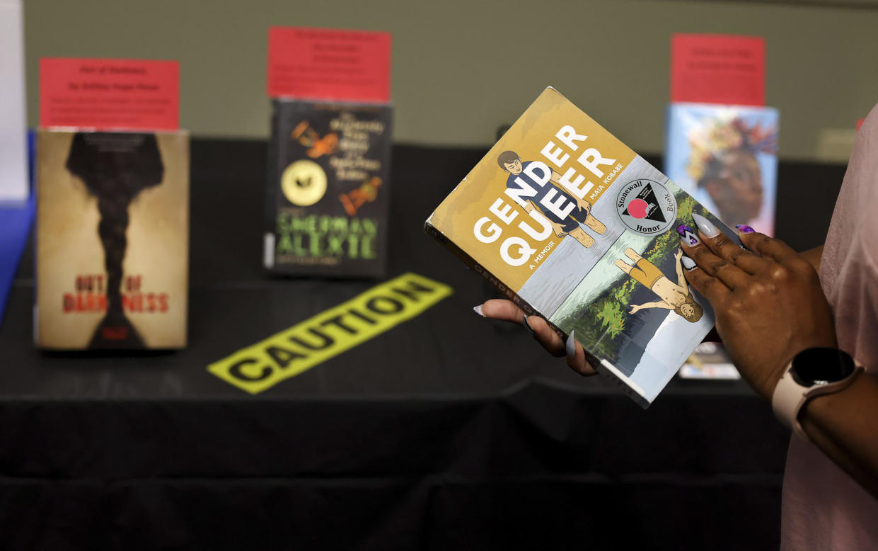 ''Gender Queer'' by Maia Kobabe is held as a selection of banned and challenged books are seen during Banned Books Week 2022, at the Lincoln Belmont branch of the Chicago Public Library on Sept. 22, 2022. (Chris Sweda/TNS via ZUMA Press Wire)