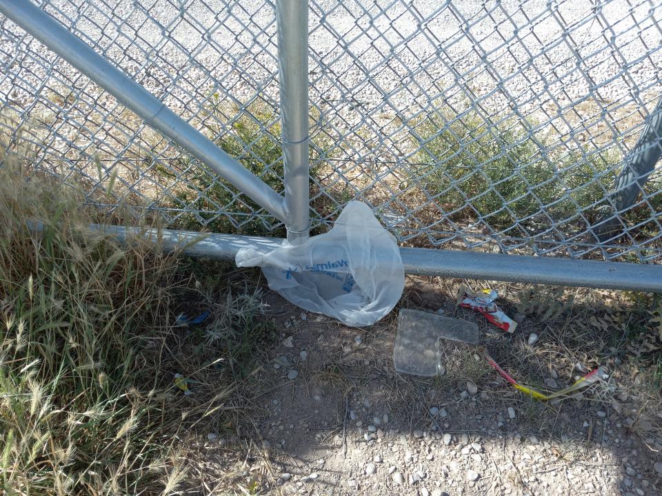 An errant plastic bag rests against the gate at the Fairgrounds Convenience Center in Artesia on April 26, 2023.