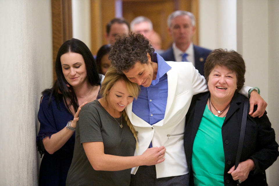 FILE - In this April, 26, 2018 file photo Bill Cosby accuser Andrea Constand, center, and supporters embrace after Cosby was found guilty in his sexual assault retrial at the Montgomery County Courthouse in Norristown, Pa. A Pennsylvania appeals court will hear arguments, Monday, Aug. 12, 2019, as Cosby appeals his sexual assault conviction. The 82-year-old Cosby is serving a three- to 10-year prison term. (Mark Makela/Pool Photo via AP, File)