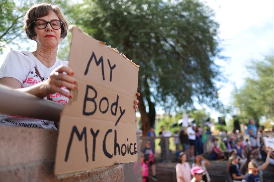 A protestor holds a sign reading ‘My Body My Choice’ at a Women’s March rally  outside the State Capitol on October 8, 2022 in Phoenix, Arizona. (Getty Images)