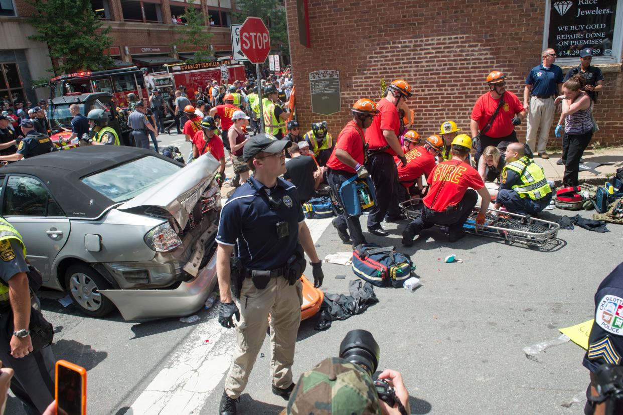 A woman receives first-aid after a man drove his car into a crowd of protesters  (AFP via Getty Images)