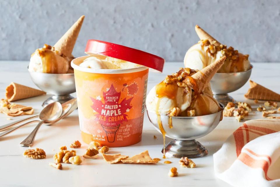 trader joe's salted maple ice cream in silver dishes, topped wtih chopped walnuts, maple syrup and sugar cone pieces