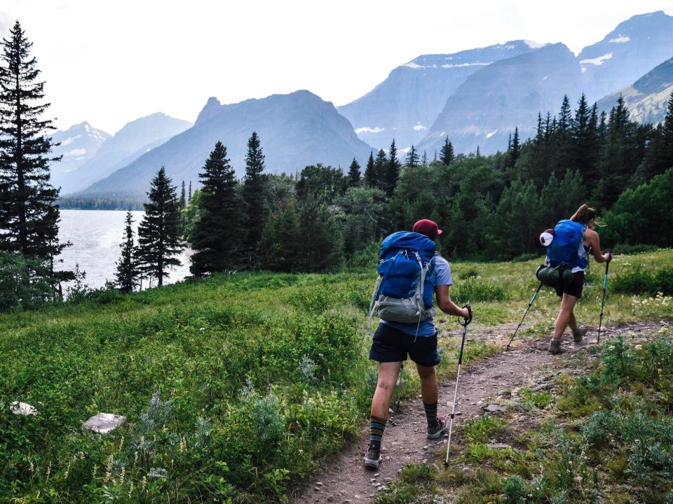 Two people hiking in Glacier National Park in Montana.