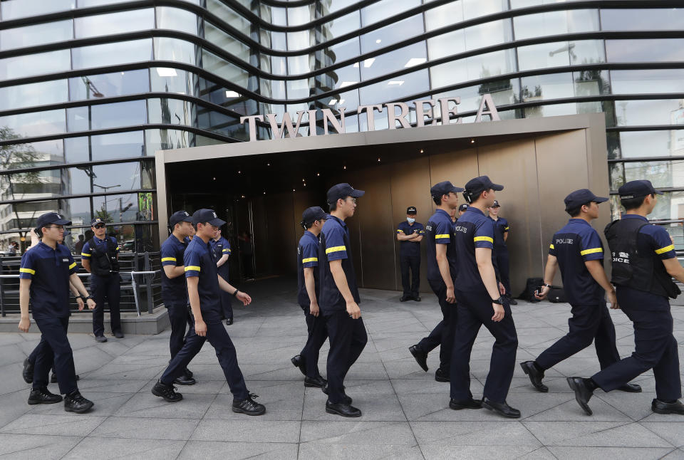 South Korean police officers patrol against possible rallies against Japan in front of a building where the Japanese embassy is located in Seoul, South Korea, Friday, July 19, 2019. South Korean police say a man has set himself on fire in front of the Japanese Embassy in Seoul amid rising trade disputes between Seoul and Tokyo. (AP Photo/Ahn Young-joon)