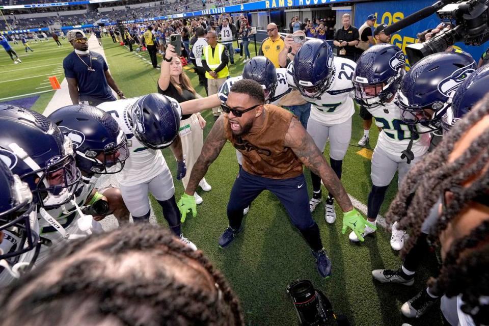 Seattle Seahawks safety Jamal Adams, center, stands in a huddle with teammates before an NFL football game against the Los Angeles Rams Sunday, Nov. 19, 2023, in Inglewood, Calif. (AP Photo/Mark J. Terrill)