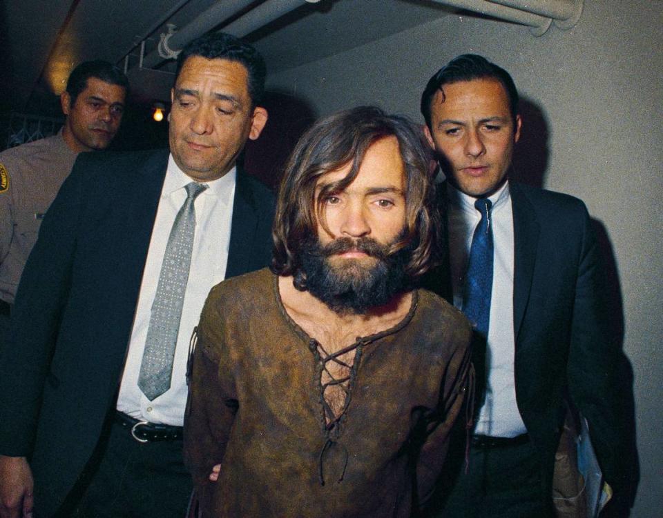 FILE - In this 1969, file photo, Charles Manson is escorted to his arraignment on conspiracy-murder charges in connection with the Sharon Tate murder case. (AP Photo/File)