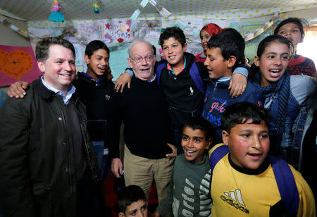 FILE PHOTO: United Nations Children's Fund (UNICEF) Executive Director Anthony Lake (3rd L) stands with Justin Forsyth (L), chief executive of Save the Children, as they visit a school inside a refugee camp in Zahle, in the Bekaa Valley March 14, 2014. REUTERS/Mohamed Azakir/File Photo