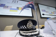 The peaked cap of David McLean, Australia's Federal Police, sits on the table prior to the Joint Investigation Team (JIT) news conference at the Eurojust building in The Hague, Netherlands, Wednesday, Feb. 8, 2023, on the results of the ongoing investigation into other parties involved in the downing of flight MH17 on 17 July 2014. The JIT investigated the crew of the Buk-TELAR, a Russian made rocket launcher, and those responsible for supplying this Russian weapon system that downed MH17. (AP Photo/Peter Dejong)