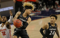 Cincinnati guard Mike Saunders (3) rebounds as Houston forward Reggie Chaney (32) and teammate Jeremiah Davenport (24) look on during the first half of an NCAA college basketball game in the final round of the American Athletic Conference men's tournament Sunday, March 14, 2021, in Fort Worth, Texas. (AP Photo/Ron Jenkins)