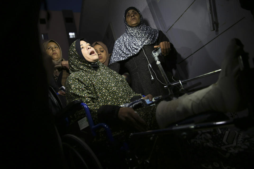 Relatives mourn in front of the morgue of Shifa hospital while wait to see the body of a woman, who was shot and killed by Israeli troops during a protest at the Gaza Strip's border with Israel, in Gaza City, Friday, Jan. 11, 2019. Spokesman Ashraf al-Kidra says the woman was shot in the head Friday at a protest site east of Gaza City. (AP Photo/Adel Hana)