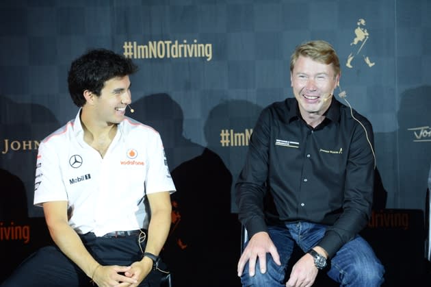 Sergio Perez and former champion Mika Hakkinen share a light moment. (Johnnie Walker Singapore)