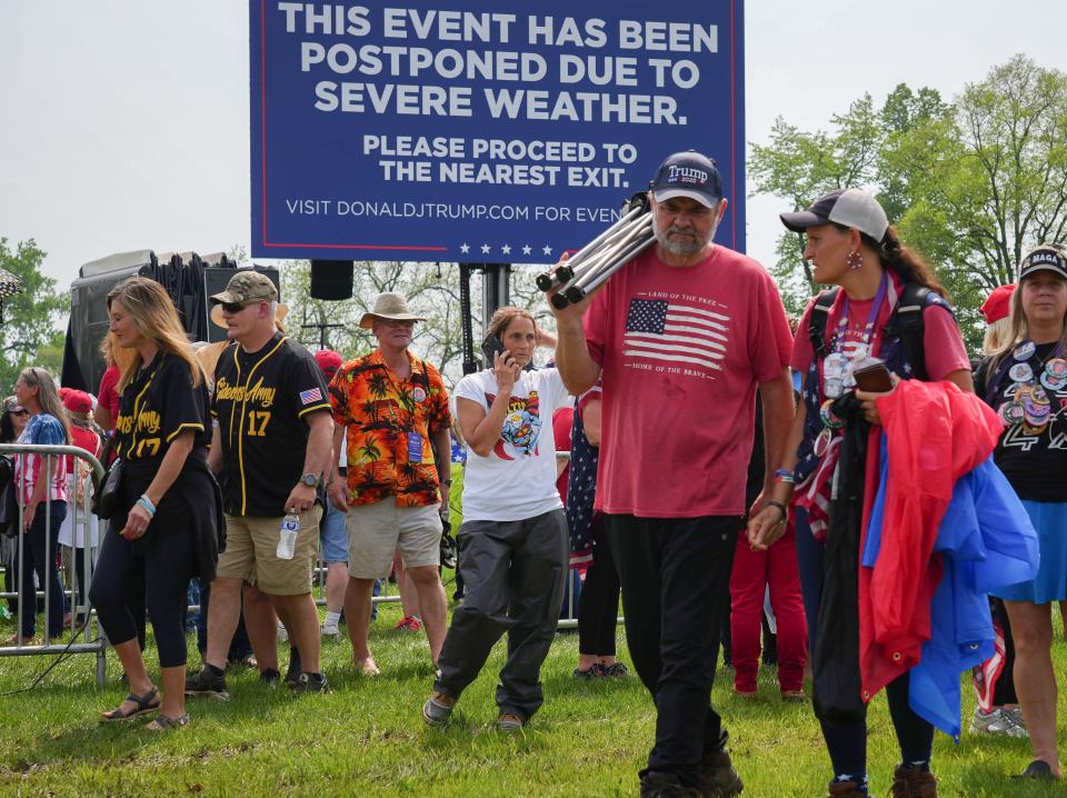 Supporters of former President Donald Trump exit the Lauridsen Amphitheater in Des Moines after Trump’s Des Moines rally was postponed due to bad weather on Saturday, May 13, 2023.