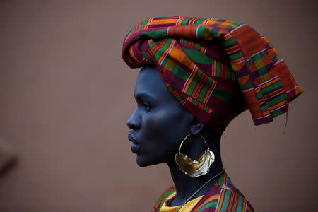 A Kenyan model Ajuma Nasanyana waits behind the scenes before the fashion show showcasing African fashion and culture during a gala marking the launch of a book called "African Twilight: The Vanishing Rituals and Ceremonies of the African Continent" at the African Heritage House in Nairobi, Kenya. March 3, 2019. REUTERS/Baz Ratner