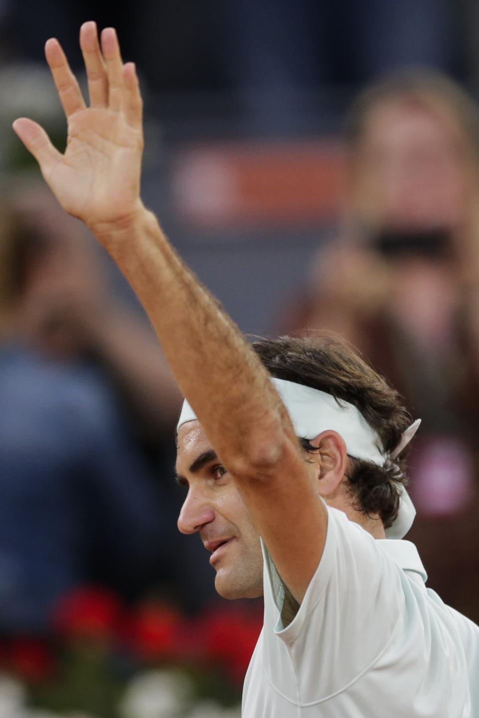 Roger Federer, from Switzerland celebrates after winning right, embraces Richard Gasquet, from France, during the Madrid Open tennis tournament in Madrid, Tuesday, May 7, 2019. (AP Photo/Bernat Armangue)