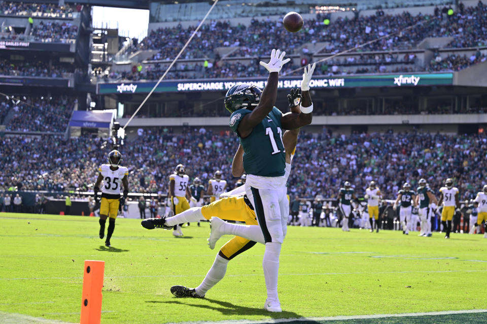 Philadelphia Eagles wide receiver A.J. Brown (11) catches a touchdown pass against Pittsburgh Steelers cornerback Ahkello Witherspoon (25) during the first half of an NFL football game between the Pittsburgh Steelers and Philadelphia Eagles, Sunday, Oct. 30, 2022, in Philadelphia. (AP Photo/Derik Hamilton)