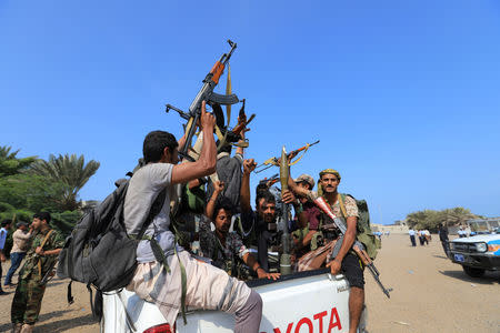 FILE PHOTO: Houthi militants ride on the back of a truck as they withdraw, part of a U.N.-sponsored peace agreement signed in Sweden earlier this month, from the Red Sea city of Hodeidah, Yemen December 29, 2018. REUTERS/Abduljabbar Zeyad/File Photo