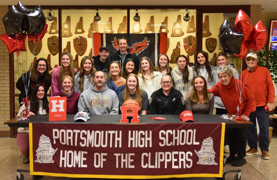 Portsmouth High School senior Maddie MacCannell, front center, is joined by girls basketball coach Tim Hopley and her friends and family after announcing she will continue her academic and athletic careers next year at the University of Hartford.