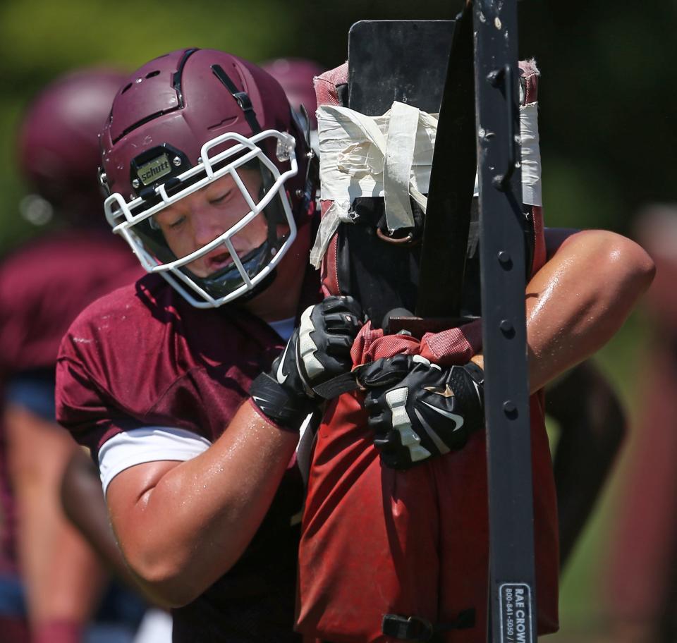 Woodridge lineman Alistair Larson participates in drills during a football practice behind the school, Thursday, Aug. 5, 2021, in Cuyahoga Falls, Ohio.