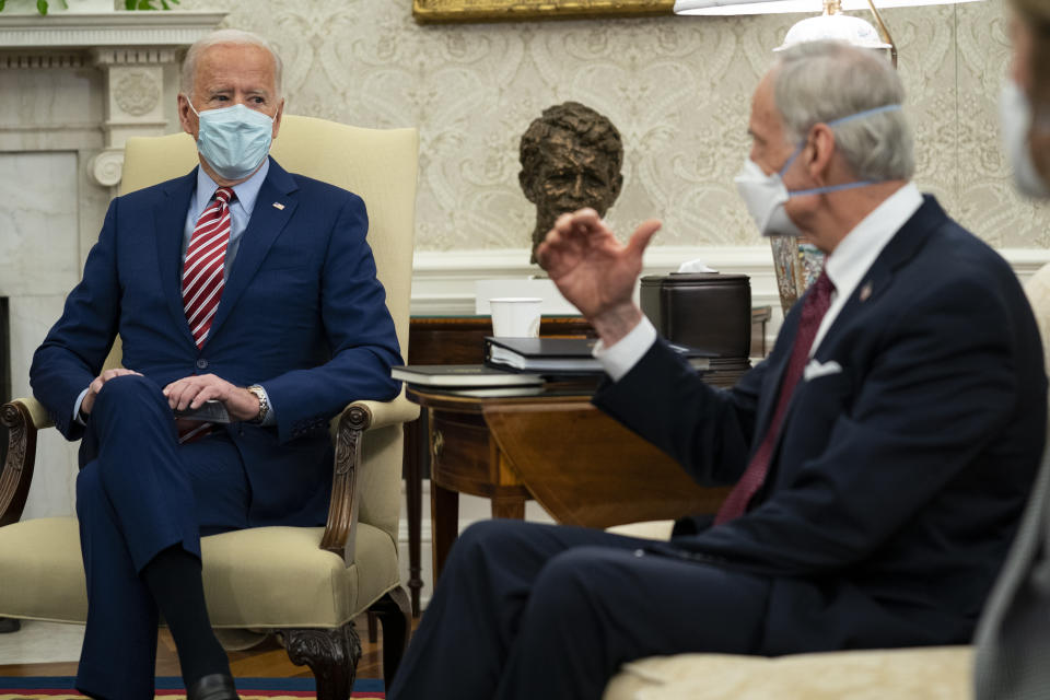 Sen. Tom Carper, D-Del., right, speaks to President Joe Biden during a meeting with lawmakers on investments in infrastructure, in the Oval Office of the White House, Thursday, Feb. 11, 2021, in Washington. (AP Photo/Evan Vucci)