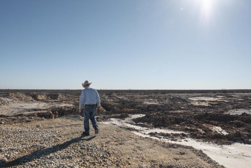 Bill Wight walks on the portion of land that was ravaged by rupturing salt water Saturday, Feb. 24, 2024, in Crane County. Crews contracted by the Railroad Commission of Texas took over a month to plug the well causing the leak.