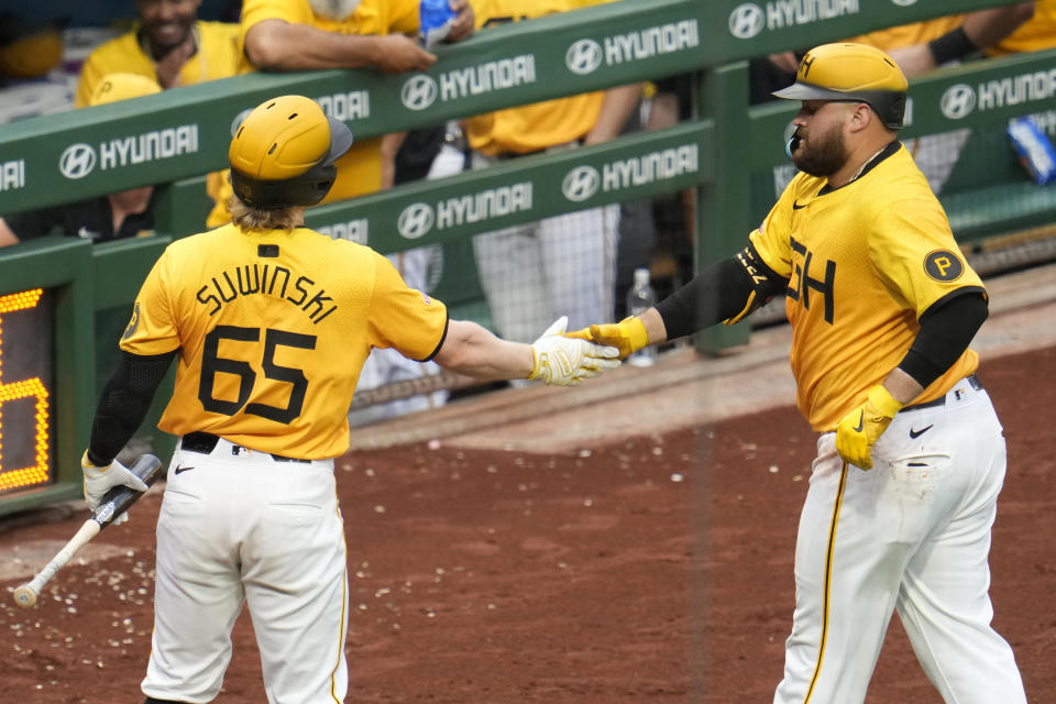 Pittsburgh Pirates' Rowdy Tellez, right, is greeted by Jack Suwinski (65) as he returns to the dugout after hitting a solo home run off New York Mets starting pitcher Luis Severino during the fourth inning of a baseball game in Pittsburgh, Friday, July 5, 2024. (AP Photo/Gene J. Puskar)