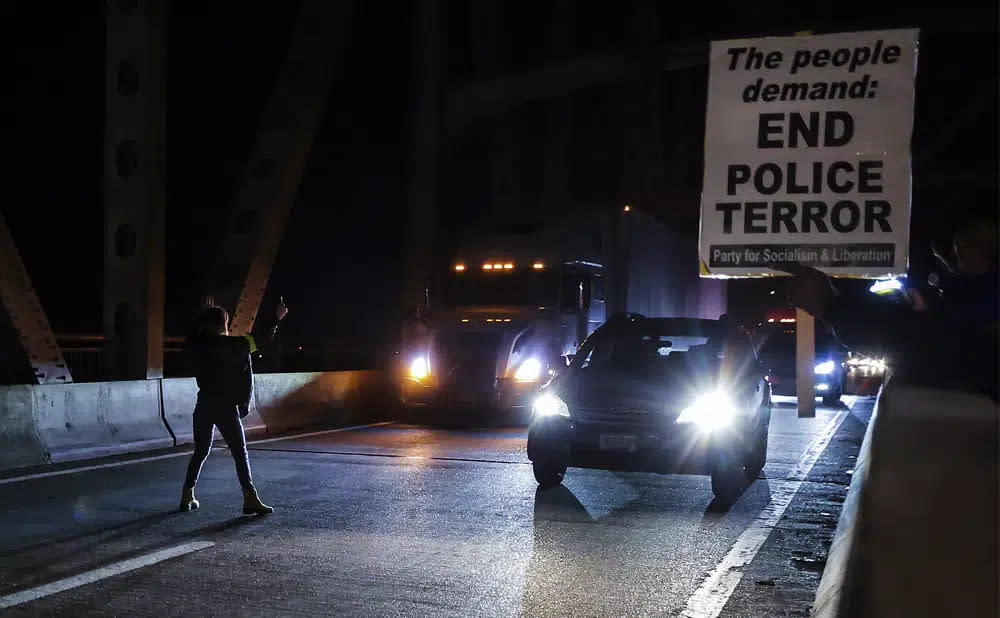 A demonstrator tries to stop traffic along the Interstate 95 bridge during a protest over the death of Tyre Nichols, Friday, Jan. 27, 2023, in Memphis, Tenn. (Patrick Lantrip/Daily Memphian via AP)