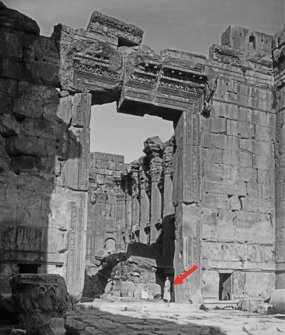 a woman standing at a temple entrance