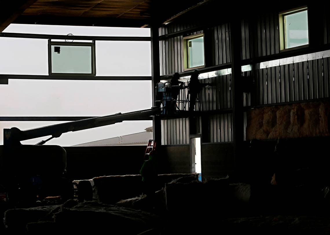 Workers install insulation inside the 40,000-square-foot Quake family entertainment center in Kennewick.