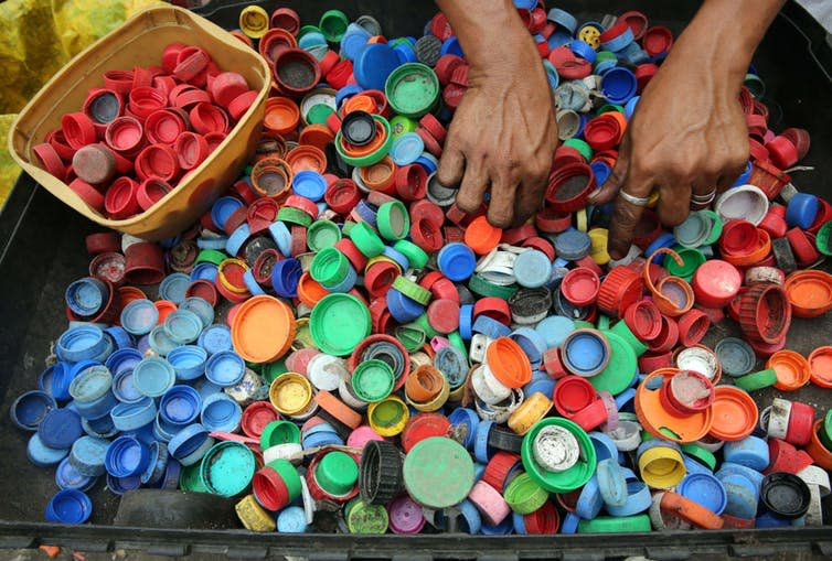 <span class="caption">Enough plastic is thrown away each year to circle the earth four times.</span> <span class="attribution"><a class="link " href="https://www.pexels.com/photo/person-hands-on-assorted-color-plastic-lid-lot-761297/" rel="nofollow noopener" target="_blank" data-ylk="slk:Pexels;elm:context_link;itc:0;sec:content-canvas">Pexels</a></span>