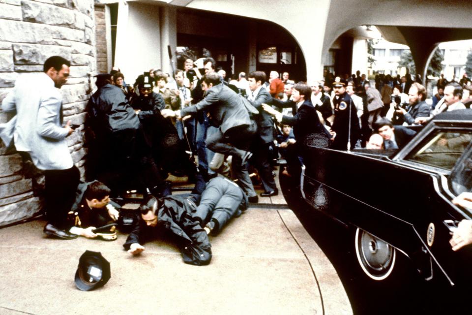 Police and Secret Service agents reacting on Monday, March 30, 1981 during the assassination attempt on then US president Ronald Reagan, after a conference outside the Hilton Hotel in Washington, D.C.