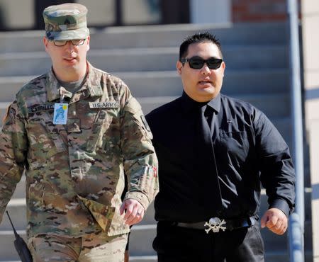 Jonathan Morita (R), a former U.S. Army soldier who was injured while searching for Sergeant Bowe Bergdahl after he deserted in Afghanistan, leaves the courthouse after testifying on the third day of sentencing proceedings in Bergdahl's court martial at Fort Bragg, North Carolina, U.S., October 26, 2017. REUTERS/Jonathan Drake