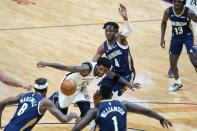 Brooklyn Nets guard Kyrie Irving (11) loses the ball as he drives the lane between New Orleans Pelicans forward Naji Marshall (8), forward Zion Williamson (1) and forward Wes Iwundu (4) in the first half of an NBA basketball game in New Orleans, Tuesday, April 20, 2021. (AP Photo/Gerald Herbert)