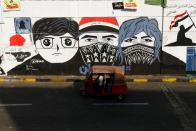 Demonstrators use a tuk-tuk during the ongoing anti-government protests in Baghdad