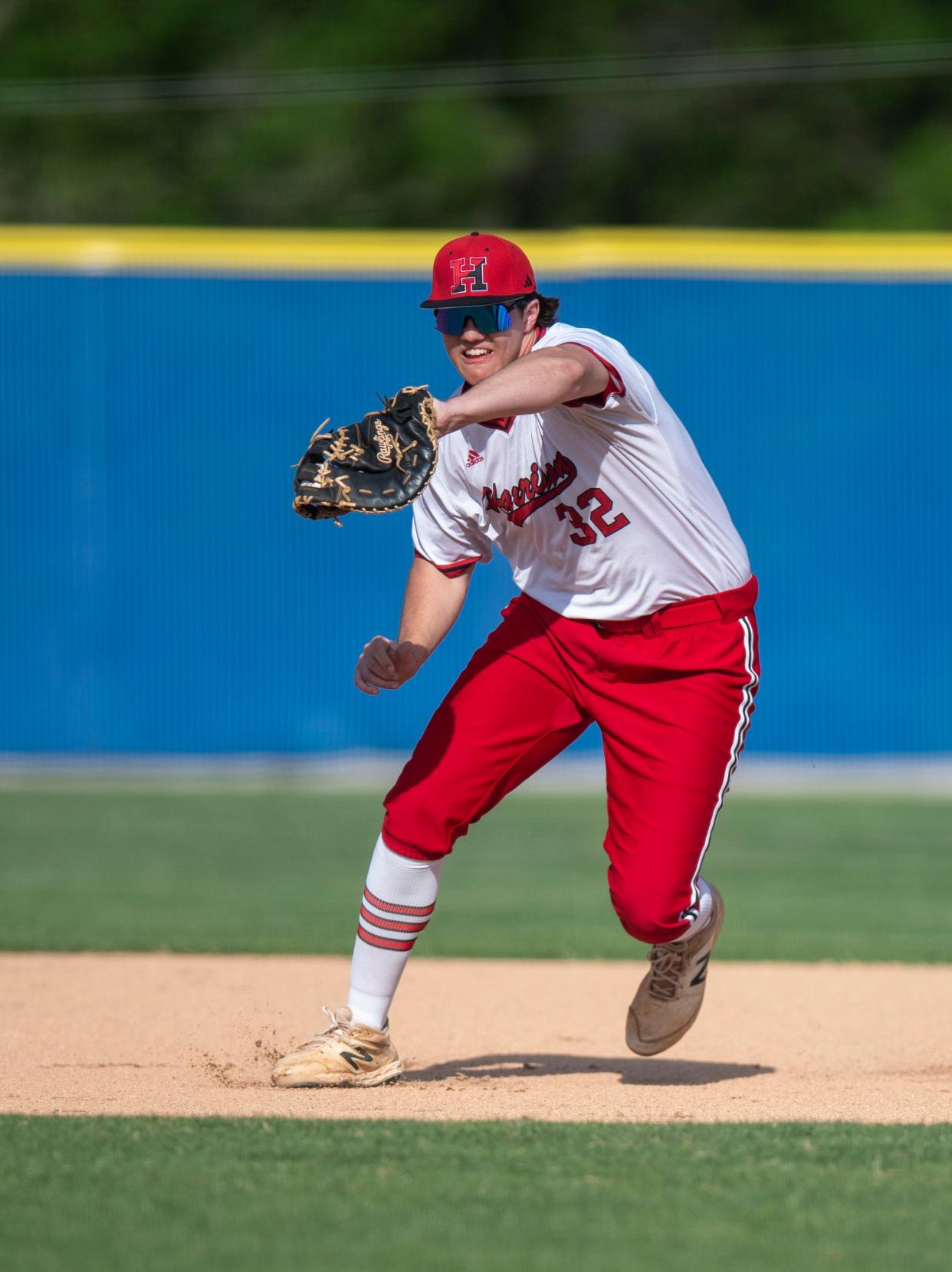 Harrison’s Brooks Thomas (32) outs a runner as the Castle Knights play the Harrison Warriors in Newburgh, Ind., Thursday, April 18, 2024.