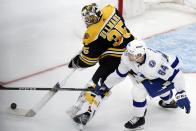 Tampa Bay Lightning's Tanner Jeannot (84) battles for the puck with Boston Bruins' Linus Ullmark (35) during the first period of an NHL hockey game, Saturday, March 25, 2023, in Boston. (AP Photo/Michael Dwyer)