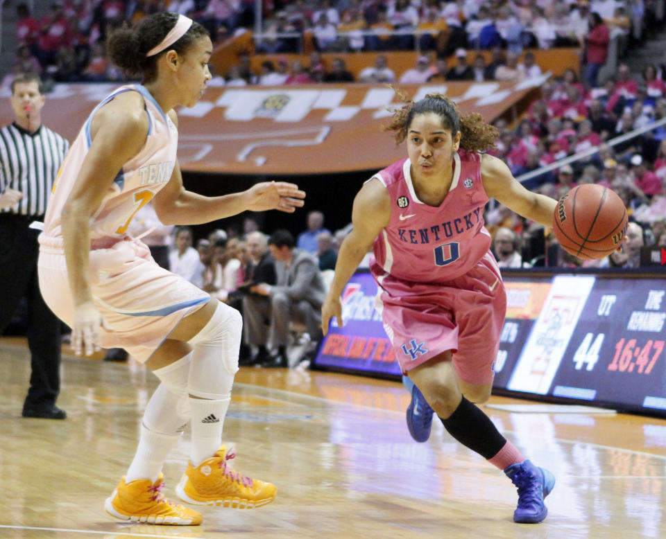 Kentucky guard Jennifer O'Neill (0) drives against Tennessee guard Andraya Carter in the second half of an NCAA college basketball game on Sunday, Feb. 16, 2014, in Knoxville, Tenn. Kentucky won 75-71. (AP Photo/Wade Payne)