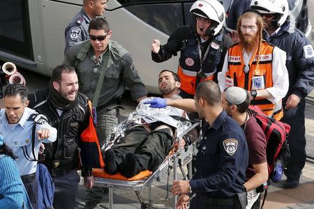 Israeli medics and emergency personnel evacuate a wounded Israeli from the scene of a stabbing in Pisgat Zeev, which lies on occupied land that Israel annexed to Jerusalem after the 1967 Middle East war, November 10, 2015. REUTERS/Ammar Awad