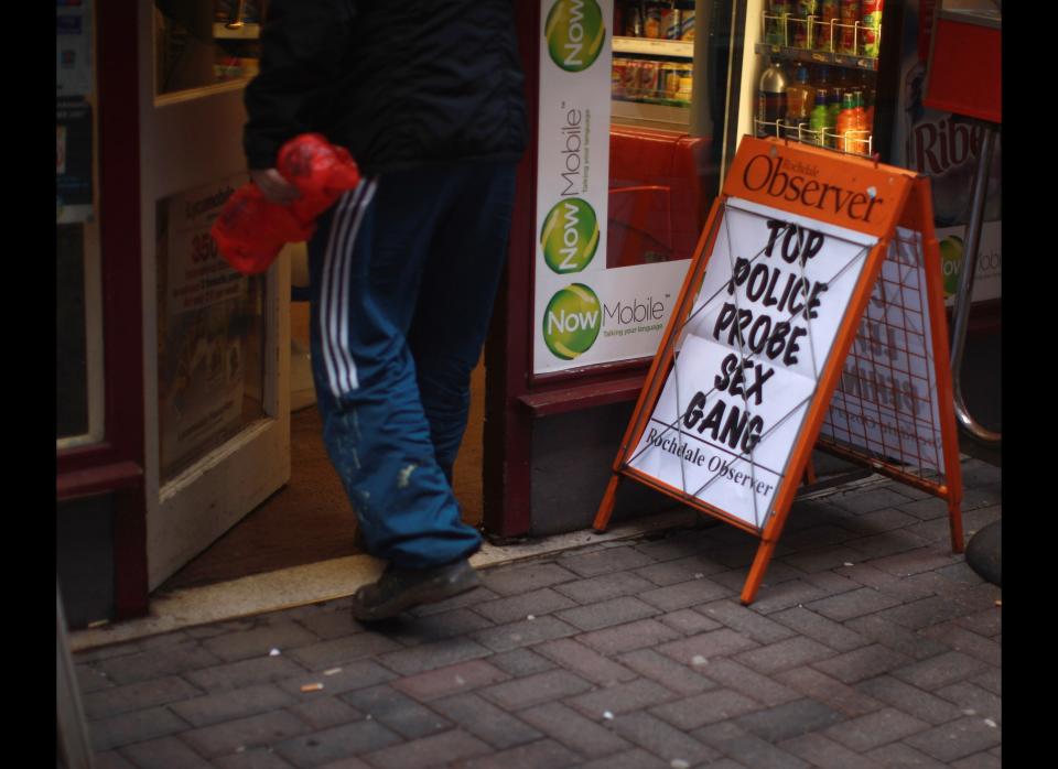 A newspaper advertising board outside a corner shop in the Lancashire town of Rochdale, England, after nine men were arrested for child sexual exploitation on Jan. 11, 2011. Greater Manchester Police arrested nine men as part of an investigation into sexual exploitation and questioned them on suspicion of rape, inciting child prostitution, allowing premises to be used for prostitution and sexual activity with a child. (Photo credit: Christopher Furlong/Getty Images)