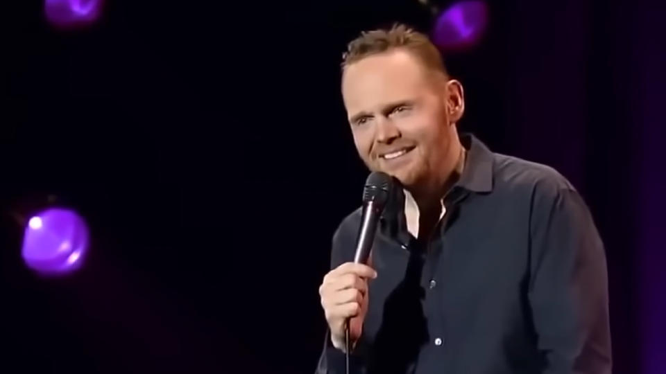 Bill Burr smiling with a microphone