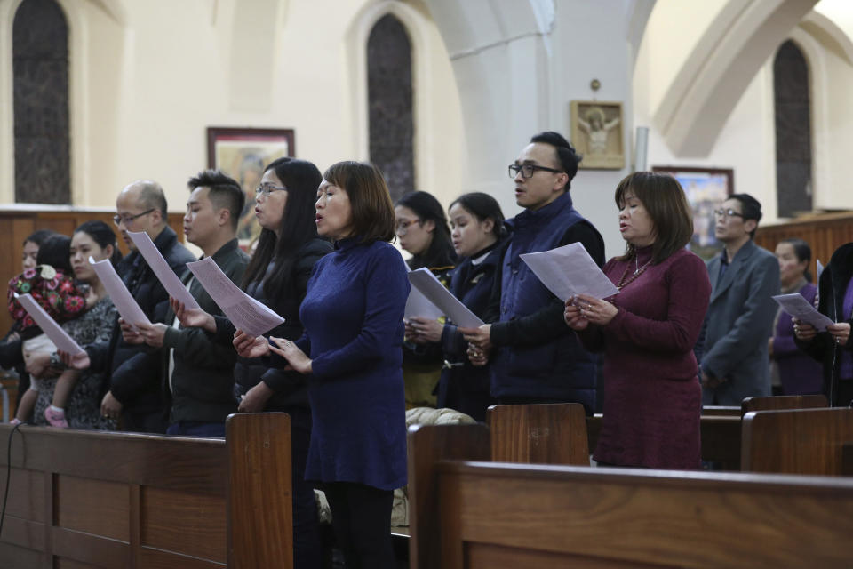 Worshippers pray during a Mass and vigil for the 39 victims found dead inside the back of a truck in Grays, Essex, at The Holy Name and Our Lady of the Sacred Heart Church, east London's Vietnamese church on Saturday, Nov. 2, 2019. All those killed were Vietnamese nationals, British police said. (Yui Mok/PA via AP)