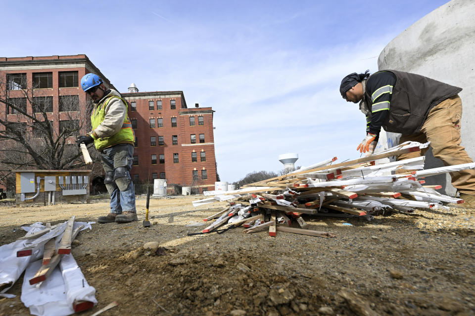 Workers clear debris on a construction site on the campus of St. Elizabeth near the Entertainment and Sports Arena, Friday, March 1, 2024, in Washington. The proposed move of the Capitals and Wizards sports teams to nearby Virginia has stoked concern in a pair of fragile Washington neighborhoods. (AP Photo/Terrance Williams)