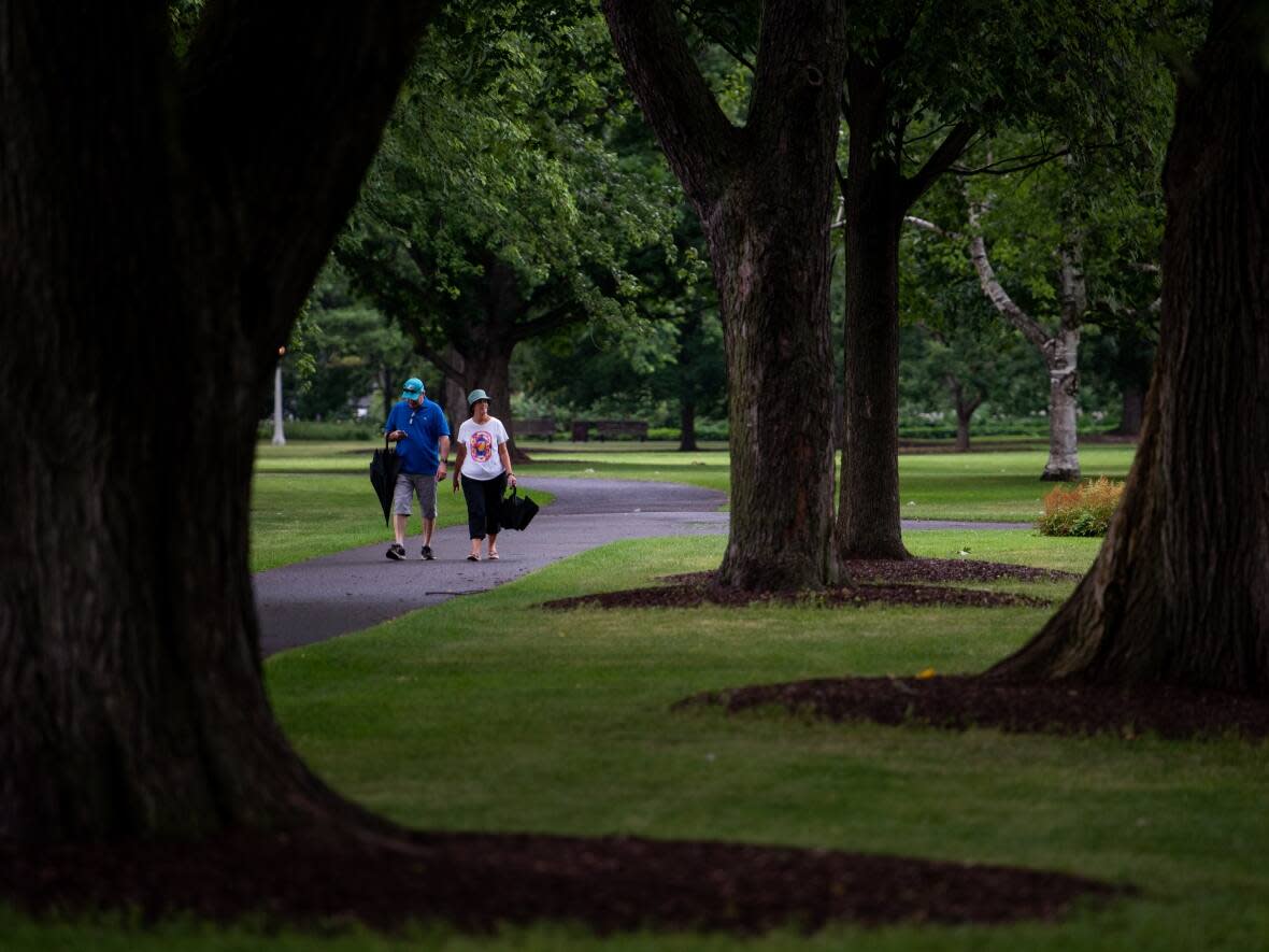 People make their way along Commissioners Park in Ottawa on Sunday, July 24, 2022. (Spencer Colby/The Canadian Press - image credit)