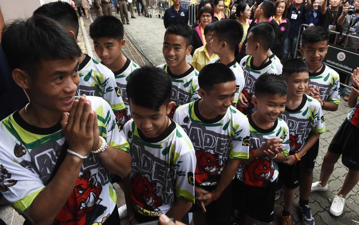 The boys' appearance at a press conference following their ordeal and discharge from hospital was carefully managed - AFP