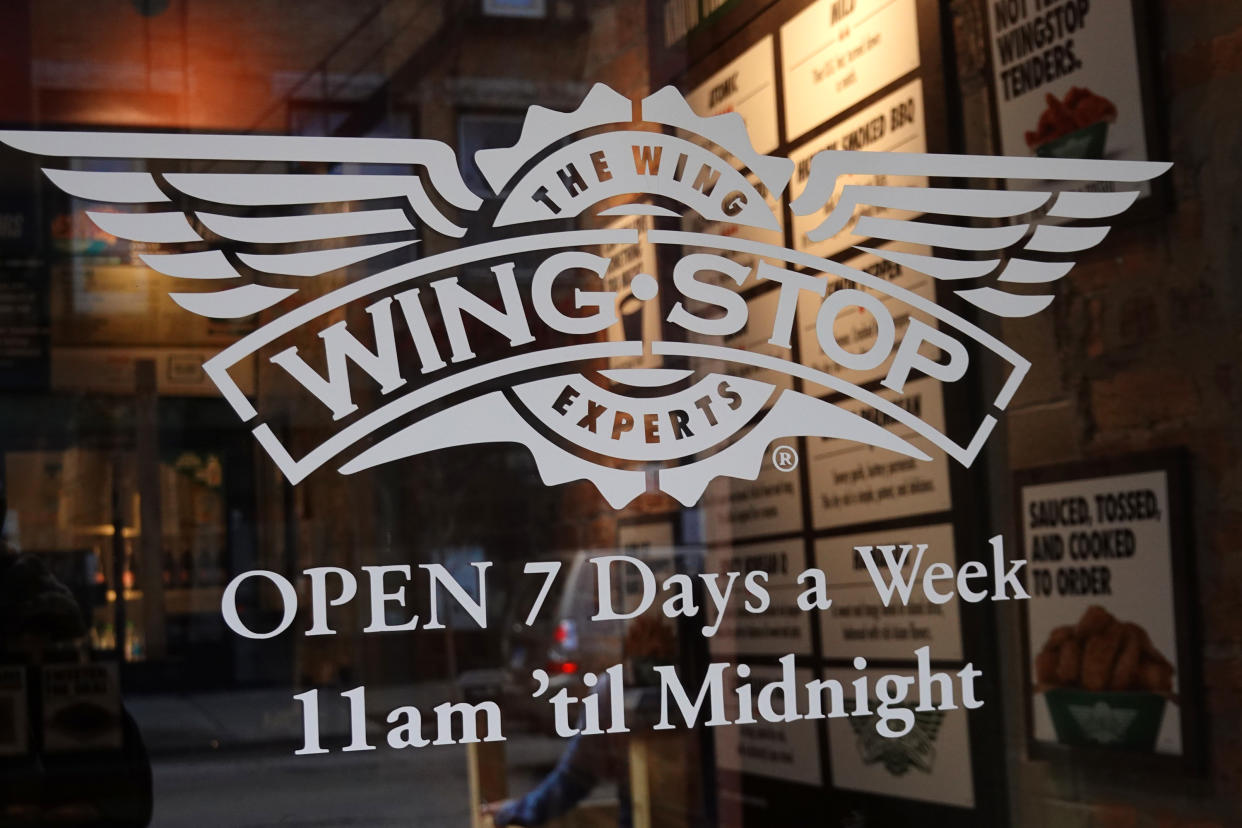 CHICAGO, ILLINOIS - MAY 06: The Wingstop logo is seen on the front door of one of the company's restaurants on May 06, 2021 in Chicago, Illinois.  Chicken prices have risen sharply this year as suppliers struggle to keep up with demand, fueled in part, by the popularity of new chicken offerings from fast-food restaurants.  (Photo by Scott Olson/Getty Images)
