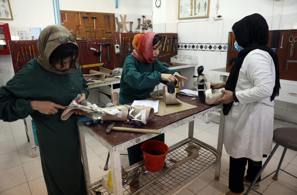 Technicians make new orthopedic devices at the ICRC hospital at the International Committee of the Red Cross’ Orthopedic Program, in Kabul, Afghanistan, Monday, March 29, 2021. In 2020, nearly 5,000 polio patients received treatment at the program, including physiotherapy, medical equipment and orthopedic devices. (AP Photo/Rahmat Gul)