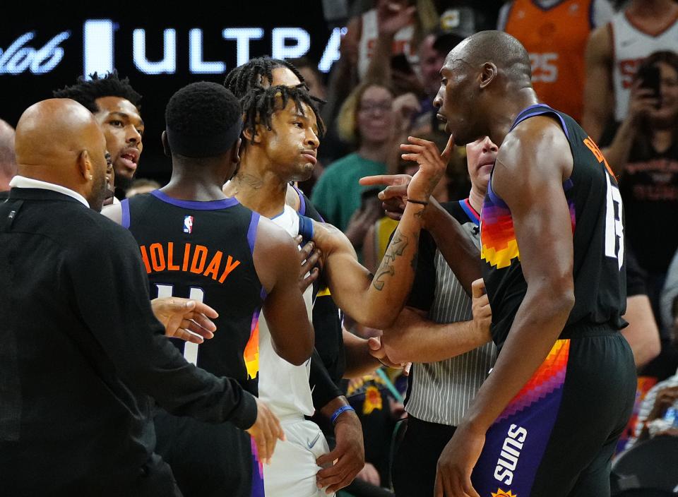 May 10, 2022; Phoenix, Arizona; USA; Suns center Bismack Biyombo and Mavericks Trey Burke argue after a foul during game 5 of the second round of the Western Conference Playoffs.