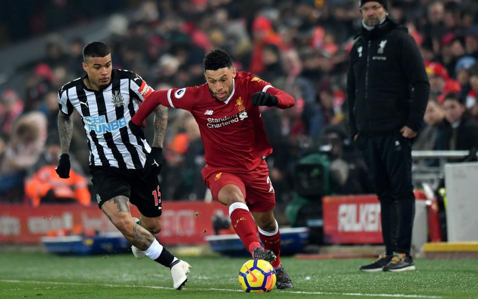 Newcastle United's Robert Kenedy (left) and Liverpool's Alex Oxlade-Chamberlain battle for the ball during the Premier League match at Anfield, Liverpool - PA/Anthony Devlin 